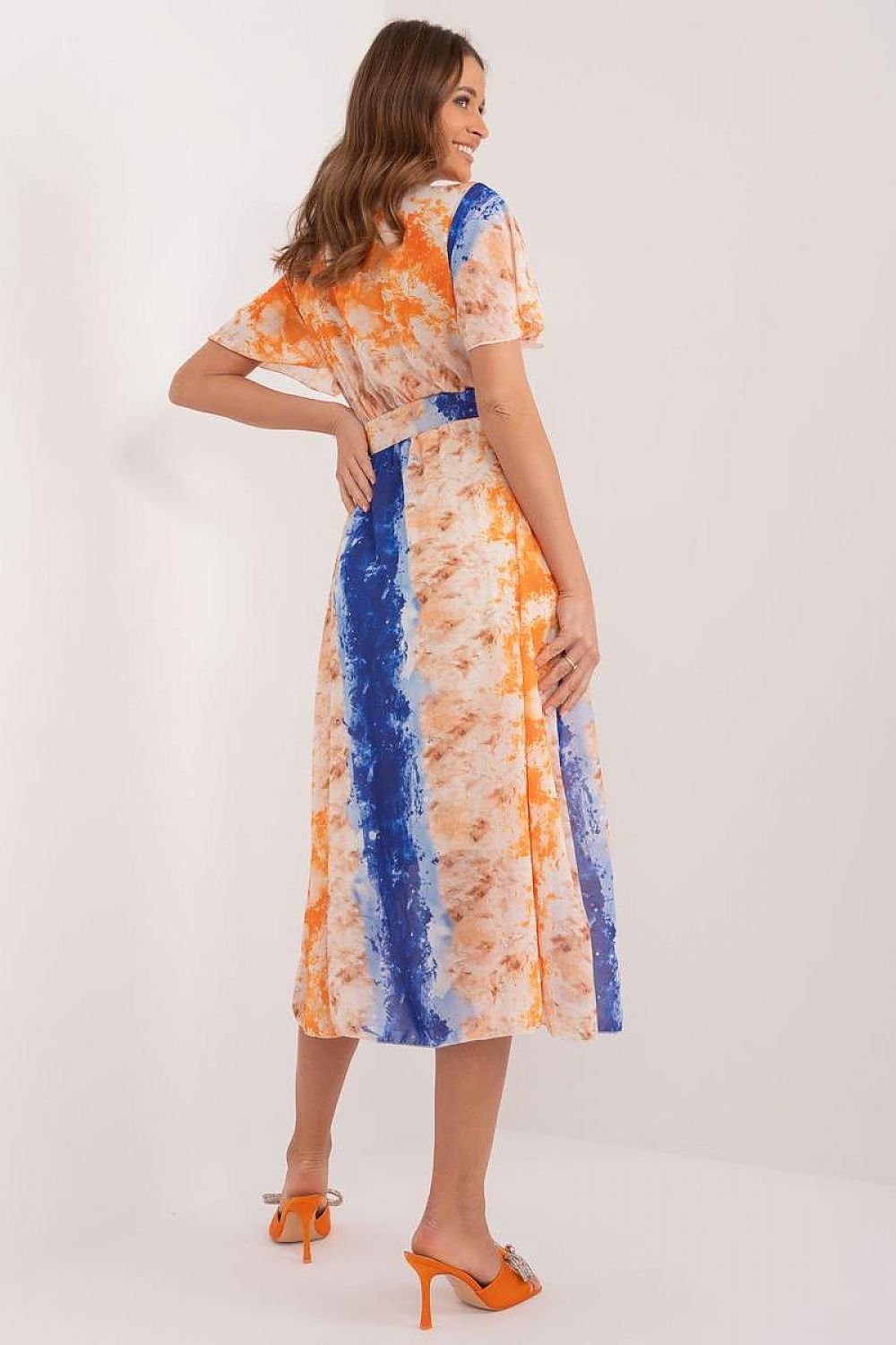 This dress embodies the perfect balance of everyday elegance, offering both comfort and style. The vibrant print adds a fun and energetic touch, making it suitable for any occasion. Its flared cut is flattering and feminine, ideal for both social gatherings and work. Crafted from easy-care polyester, it maintains its pristine look with minimal effort. The midi length offers versatility, while the short sleeves and heart neckline with an envelope cut enhance the dress's subtle feminine charm.