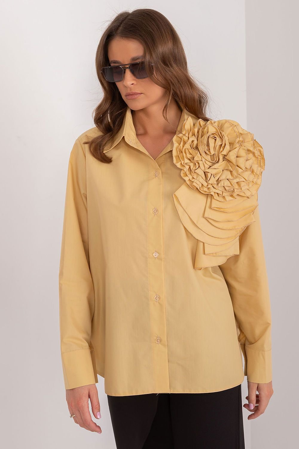 A sophisticated women's shirt made of smooth, breathable cotton, featuring a large decorative fabric flower on the front for a unique and elegant touch. The button-down design and long sleeves make it perfect for formal occasions, offering comfort and style for all-day wear.






