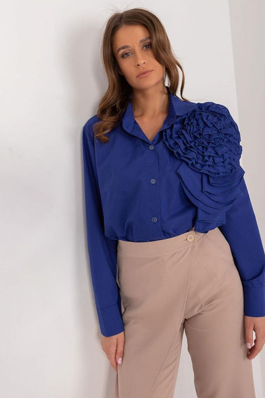 A sophisticated women's shirt made of smooth, breathable cotton, featuring a large decorative fabric flower on the front for a unique and elegant touch. The button-down design and long sleeves make it perfect for formal occasions, offering comfort and style for all-day wear.






