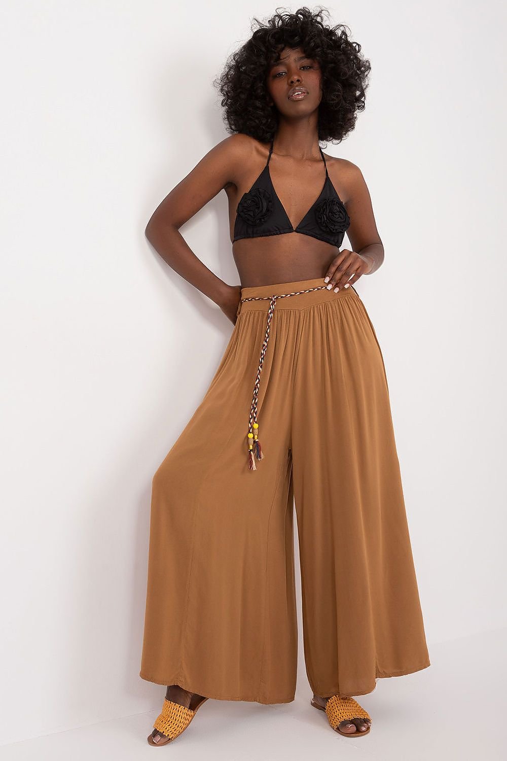 High-waisted viscose pants with an elastic waistband for comfort. Featuring wide legs and a decorative tie belt for a stylish, adjustable fit.

