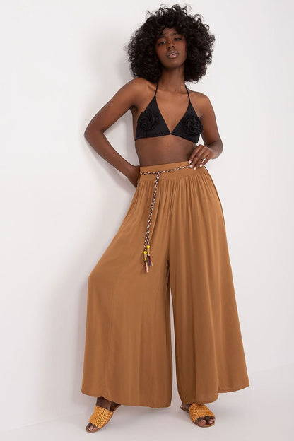 High-waisted viscose pants with an elastic waistband for comfort. Featuring wide legs and a decorative tie belt for a stylish, adjustable fit.

