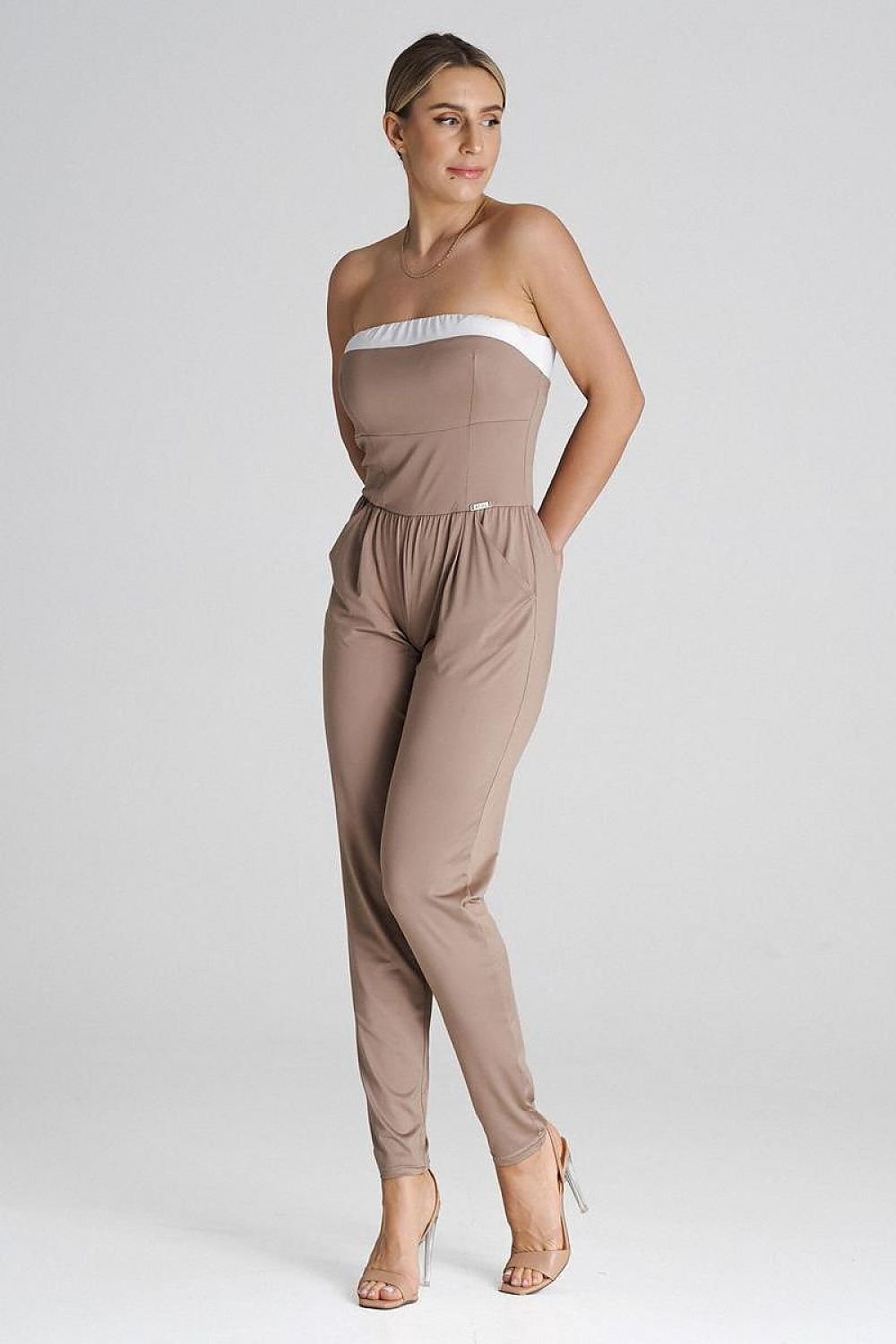 Elegant loose-fitting jumpsuit featuring a strapless top with a contrasting insert, long pleated legs, and slide pockets for a classic yet modern style.






