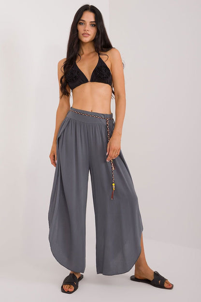 Boho-style seam pants made from smooth material with a high waist that accentuates the figure. Featuring wide legs with slits for freedom of movement, a waist tie for a perfect fit, and a minimalist design without pockets, these pants offer comfort and elegance for casual and everyday wear.

