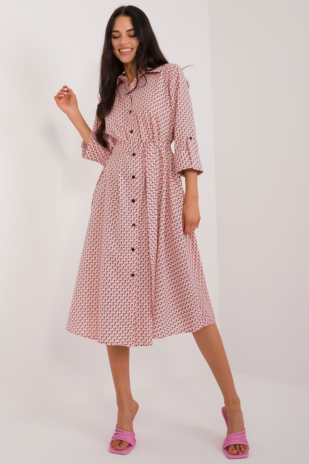 A versatile shirt dress with a flared cut, midi length, and 3/4 sleeves, featuring a muted print, tie belt, buttons, and practical slip pockets, perfect for everyday wear and work.






