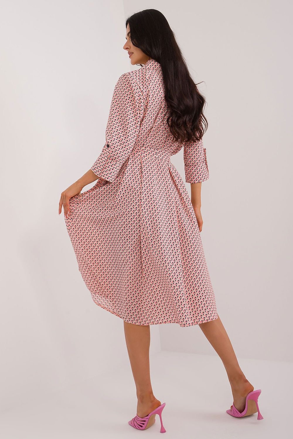 A versatile shirt dress with a flared cut, midi length, and 3/4 sleeves, featuring a muted print, tie belt, buttons, and practical slip pockets, perfect for everyday wear and work.






