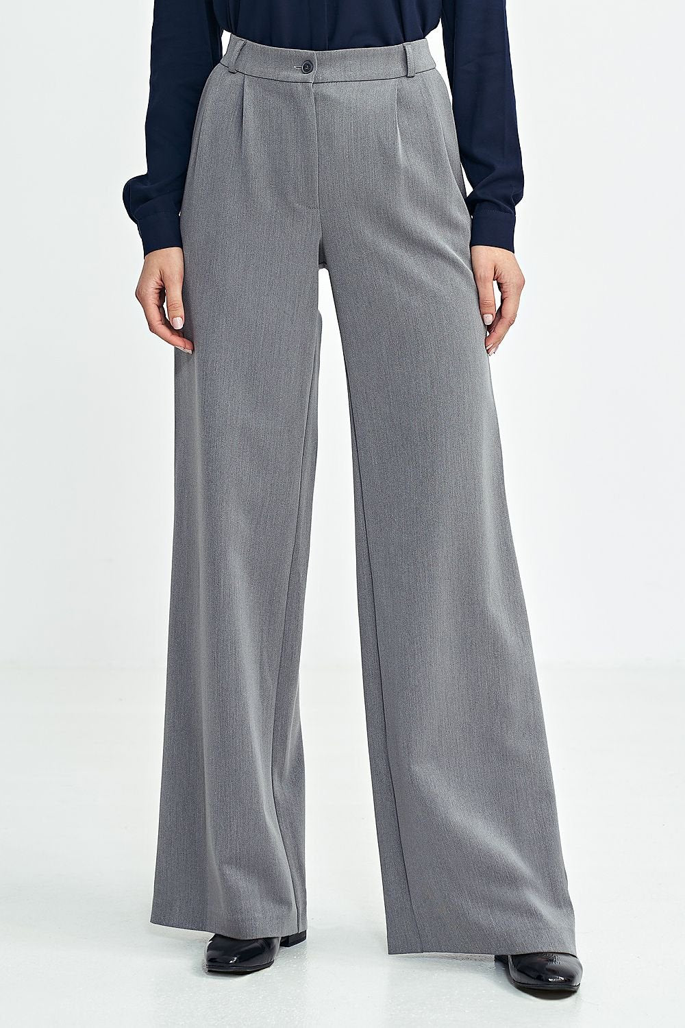 Elegant women's relaxed fit pants with subtly contrasting tennis-type stripes, offering a sophisticated touch. Featuring a medium rise, decorative front pleats for structure, and a wide leg cut for a fashionable casual look. Includes zipper and button closure, front pockets, imitation back pockets, and belt loops for customization.

