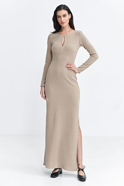 beige Fitted fit-and-flare dress made of ribbed knit fabric, featuring a round neckline with a subtle teardrop detail, long sleeves, and a maxi length. The cut under the bust accentuates the waist, while the side seam slit allows for ease of movement, making it perfect for both everyday and special occasions.






