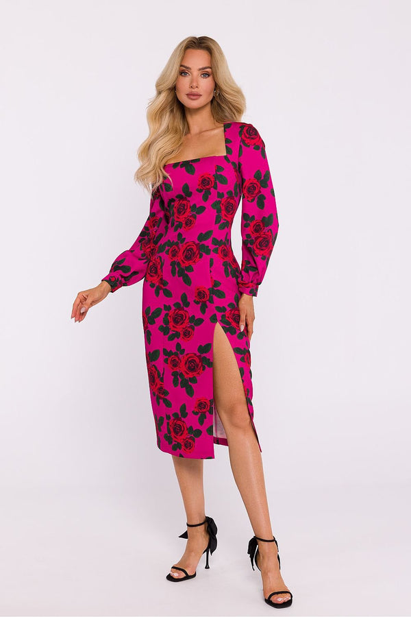 Woman wearing a vibrant fuchsia pink midi dress with red rose print, long puff sleeves, square neckline, and thigh-high slit, styled with black strappy high heels.