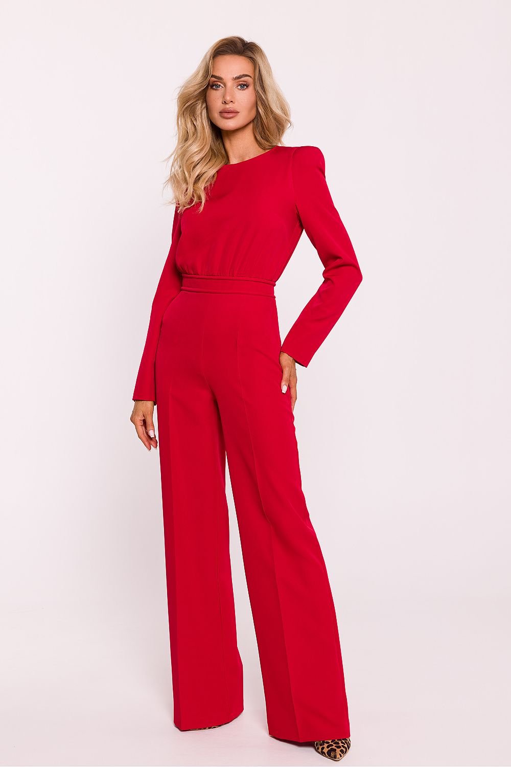 Sophisticated women's jumpsuit featuring a fitted top with long sleeves, shoulder pads, slightly wide-leg pants, and a decorative back zipper, crafted in Poland for a modern and elegant look.






