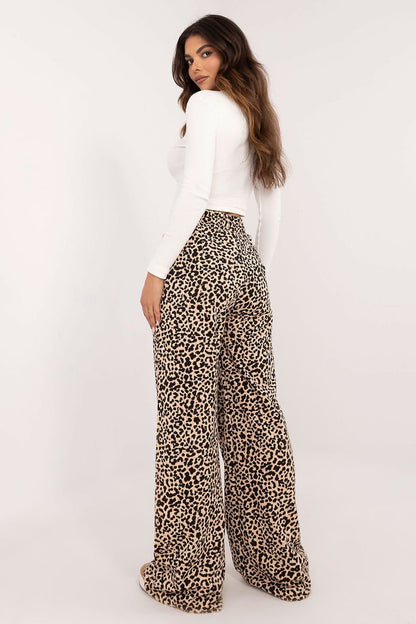 A casual women's set featuring a ribbed long-sleeve blouse with a round neckline and subtle front inscription, paired with high-waisted pants with wide legs and an animal print motif, combining comfort and bold style for everyday wear.