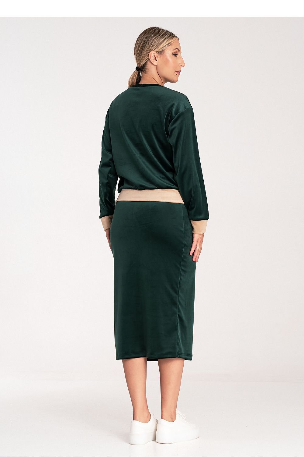 A women's velour set featuring a two-tone blouse with long sleeves and a round neckline, paired with a pencil skirt with a side slit and wide elastic waistband. Unlined for a relaxed fit and stylish look.






