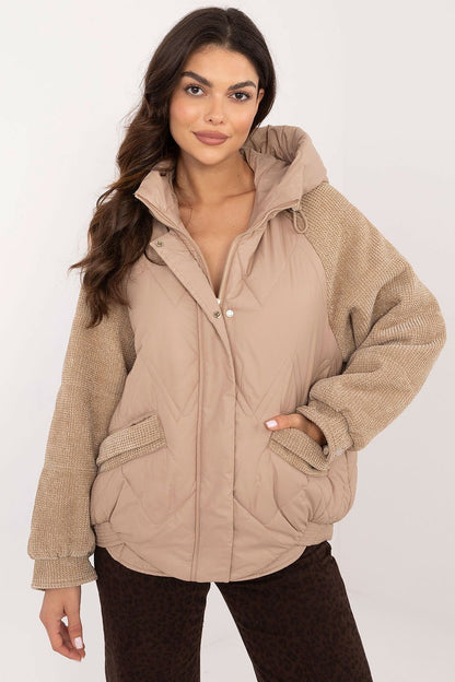 A fashionable women's casual jacket with striking corduroy sleeves, perfect for everyday outings in the autumn-winter season. Made of durable polyester, it features a smooth pattern, decorative quilting, and a standard length. Equipped with a hood, zipper and snap fastening, zippered slip pockets, and a lined interior, it's an ideal lighter option for cooler days.






