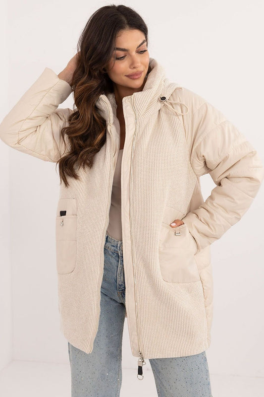 A stylish women's casual jacket with a corduroy front and hood, perfect for fall, winter, and spring. Made from durable polyester, it features decorative quilting, synthetic insulation for warmth, and a zipper closure with additional snaps for wind protection. With slide-in pockets and an inner lining for comfort, it combines modern design and practicality for everyday wear.