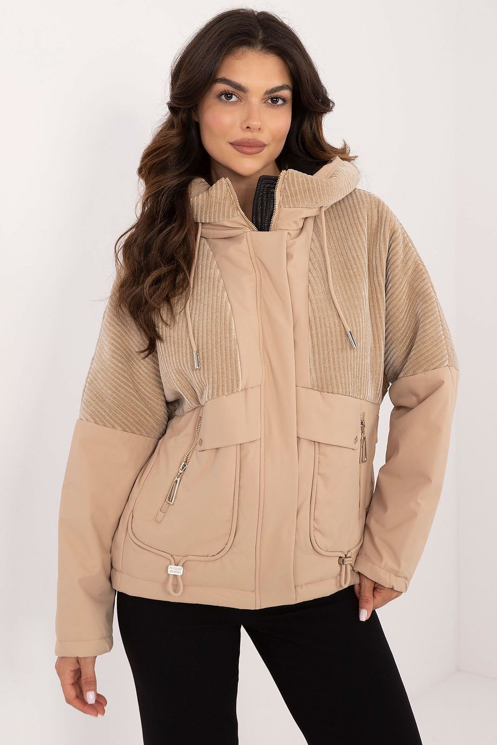 A casual women's transitional quilted jacket made from durable polyester, perfect for autumn-winter outings. Featuring a hood for protection from wind and light rain, zippered slip pockets, and a zipper and snap fastening for comfort. The smooth pattern and lightweight design make it ideal for the transitional seasons, offering both style and functionality.