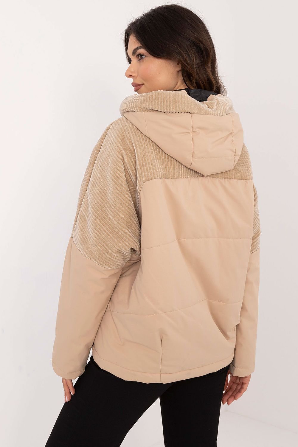 A casual women's transitional quilted jacket made from durable polyester, perfect for autumn-winter outings. Featuring a hood for protection from wind and light rain, zippered slip pockets, and a zipper and snap fastening for comfort. The smooth pattern and lightweight design make it ideal for the transitional seasons, offering both style and functionality.