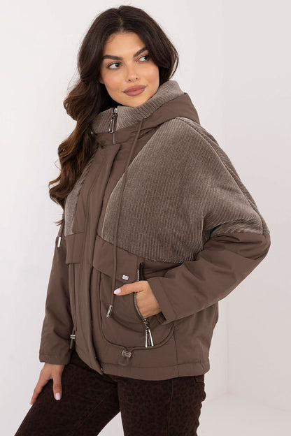 A casual women's transitional quilted jacket made from durable polyester, perfect for autumn-winter outings. Featuring a hood for protection from wind and light rain, zippered slip pockets, and a zipper and snap fastening for comfort. The smooth pattern and lightweight design make it ideal for the transitional seasons, offering both style and functionality.