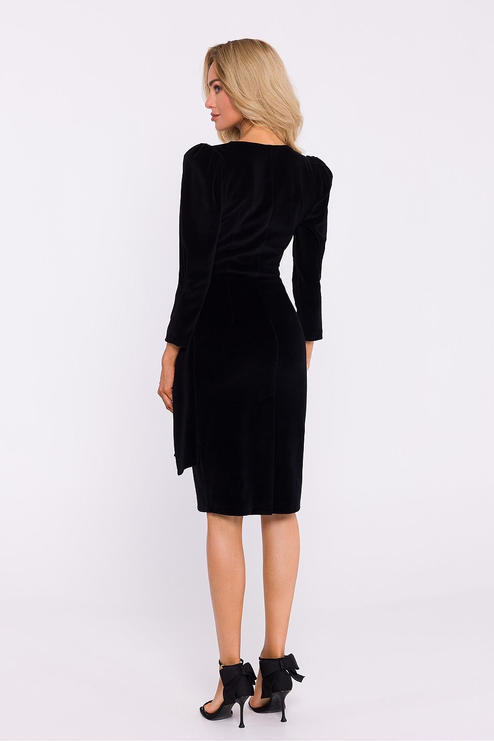 An elegant velour knit dress featuring an envelope cut top, decorative sash, knee-length pencil bottom with a high back slit, 7/8 sleeves with shoulder creases, and a concealed side zipper, perfect for special occasions. Designed and sewn in Poland.






