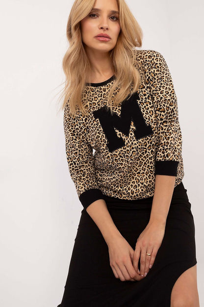 Casual blouse with animal motif pattern, 3/4-length sleeves, round neckline, and front patch detail for a stylish and comfortable everyday look.