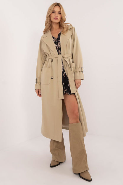 Elegant calf-length trench coat with double-breasted button closure, tie belt, slide-in pockets, and lined lapels. Perfect for transitional seasons.






