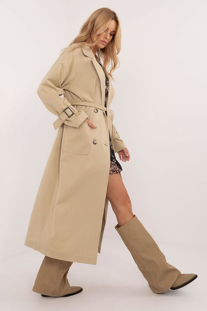 Elegant calf-length trench coat with double-breasted button closure, tie belt, slide-in pockets, and lined lapels. Perfect for transitional seasons.






