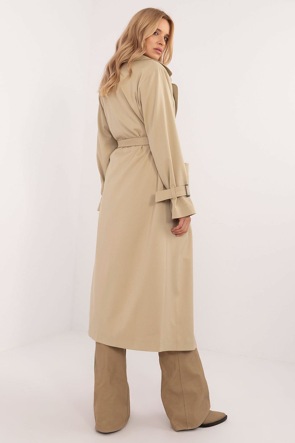 Elegant calf-length trench coat with double-breasted button closure, tie belt, slide-in pockets, and lined lapels. Perfect for transitional seasons.






