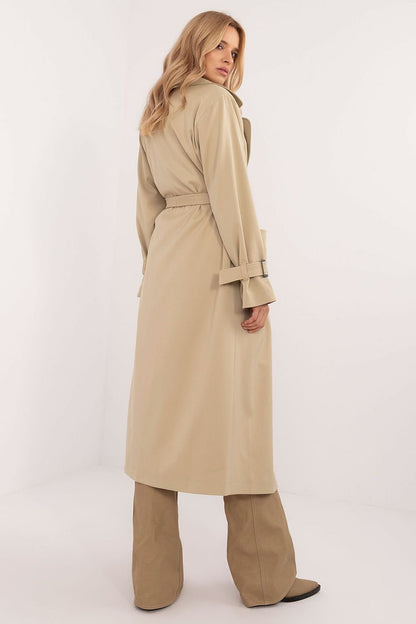 Elegant calf-length trench coat with double-breasted button closure, tie belt, slide-in pockets, and lined lapels. Perfect for transitional seasons.






