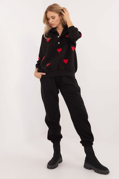 A cozy women's casual set featuring a long-sleeve hooded sweatshirt with a half-zip fastening and adorable heart-shaped patches. Paired with high-waisted jogger pants with ribbed cuffs, a tie waist, and side slip pockets, this set offers warmth, comfort, and flexibility. Made from a cotton-elastane blend, it's perfect for colder days and stylish everyday outings.






