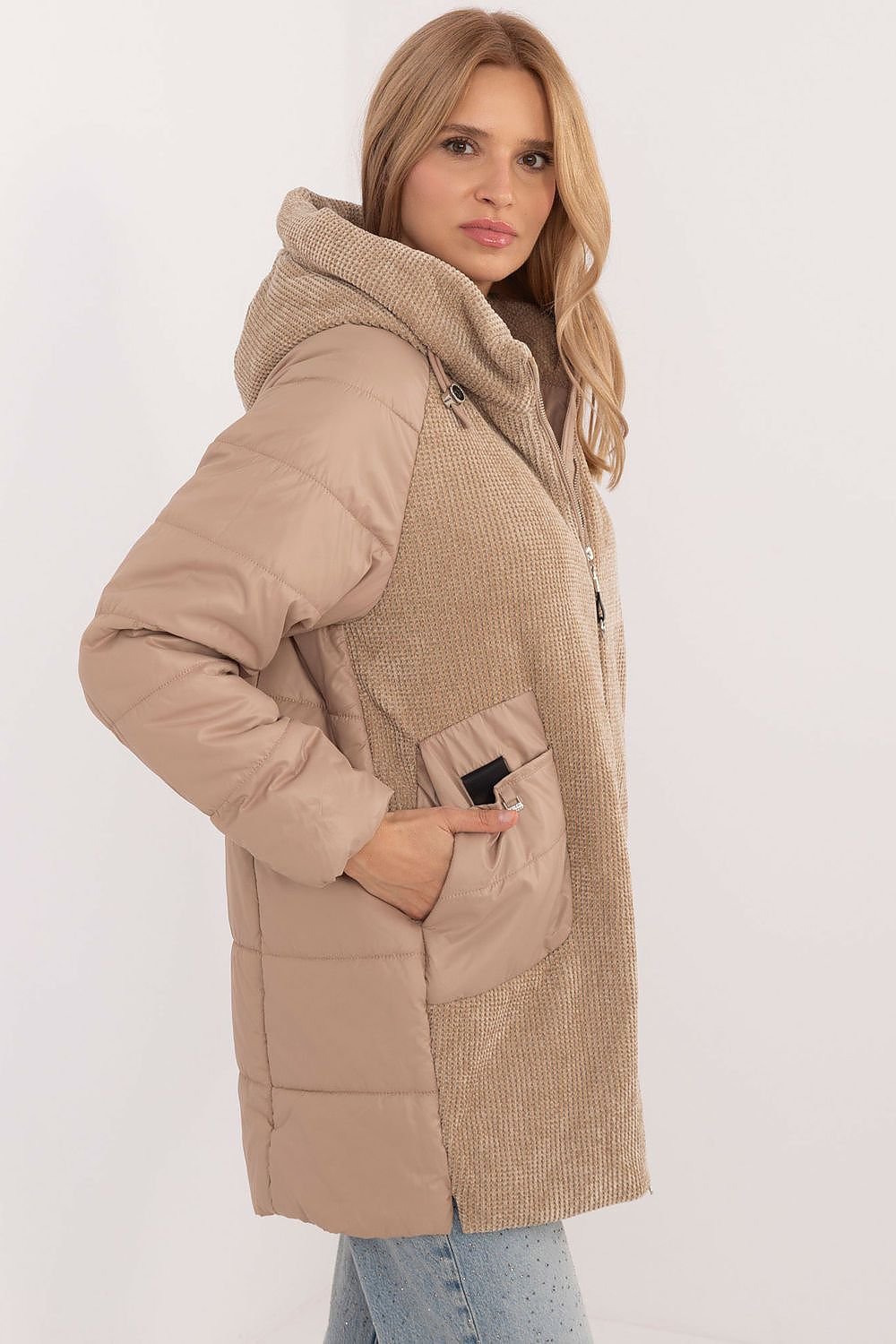 A stylish women's casual jacket with a corduroy front and hood, perfect for fall, winter, and spring. Made from durable polyester, it features decorative quilting, synthetic insulation for warmth, and a zipper closure with additional snaps for wind protection. With slide-in pockets and an inner lining for comfort, it combines modern design and practicality for everyday wear.