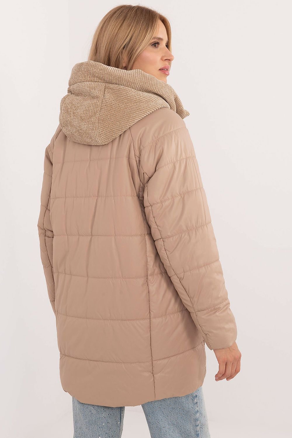 A stylish women's casual jacket with a corduroy front and hood, perfect for fall, winter, and spring. Made from durable polyester, it features decorative quilting, synthetic insulation for warmth, and a zipper closure with additional snaps for wind protection. With slide-in pockets and an inner lining for comfort, it combines modern design and practicality for everyday wear.