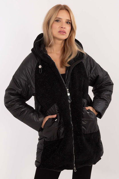 A stylish women's casual jacket with a corduroy front and hood, perfect for fall, winter, and spring. Made from durable polyester, it features decorative quilting, synthetic insulation for warmth, and a zipper closure with additional snaps for wind protection. With slide-in pockets and an inner lining for comfort, it combines modern design and practicality for everyday wear.