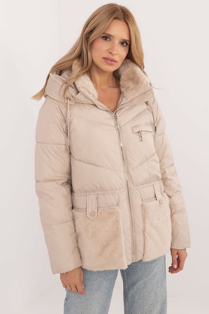 A cozy women's casual quilted jacket made from high-quality polyester, featuring synthetic insulation for warmth and comfort. Equipped with a practical hood, zipper closure with snaps, and slide-in pockets, this standard-length jacket offers protection against cold weather while ensuring style and functionality for autumn and winter outings.