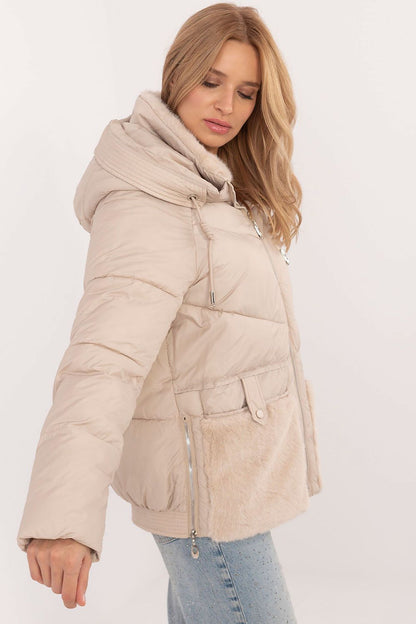 A cozy women's casual quilted jacket made from high-quality polyester, featuring synthetic insulation for warmth and comfort. Equipped with a practical hood, zipper closure with snaps, and slide-in pockets, this standard-length jacket offers protection against cold weather while ensuring style and functionality for autumn and winter outings.