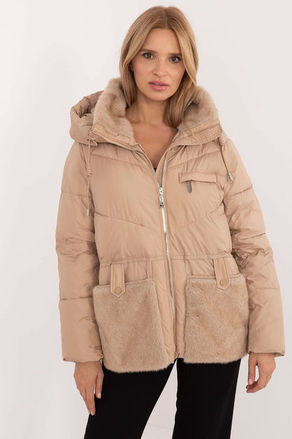 A cozy women's casual quilted jacket made from high-quality polyester, featuring synthetic insulation for warmth and comfort. Equipped with a practical hood, zipper closure with snaps, and slide-in pockets, this standard-length jacket offers protection against cold weather while ensuring style and functionality for autumn and winter outings.