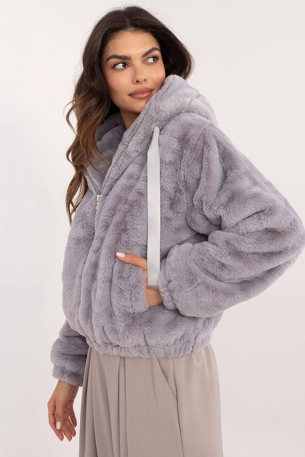 A cozy women's casual fur jacket made of soft viscose, designed for everyday outings and work in the autumn/winter season. Featuring a zippered closure, slip pockets, long sleeves, and a hood for wind protection, this standard-length jacket combines comfort, style, and practicality for transitional weather.






