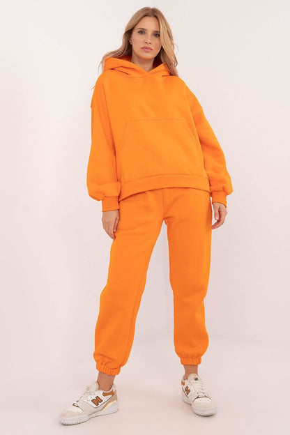 A cozy orange women's casual set featuring a long-sleeve hooded sweatshirt with a kangaroo pocket and ribbed cuffs, paired with high-waisted jogger pants. Made from a warm cotton-polyester blend, the set ensures comfort and durability for colder days. The pants have a drawstring waist, slip-in side pockets, and ribbed leg cuffs for a snug fit. Perfect for stylish and practical everyday wear.






