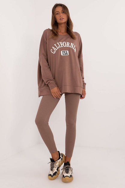 A stylish women's set featuring a long-sleeve printed sweatshirt with a round neckline, paired with figure-flattering ribbed leggings, offering a comfortable and modern look for everyday wear.