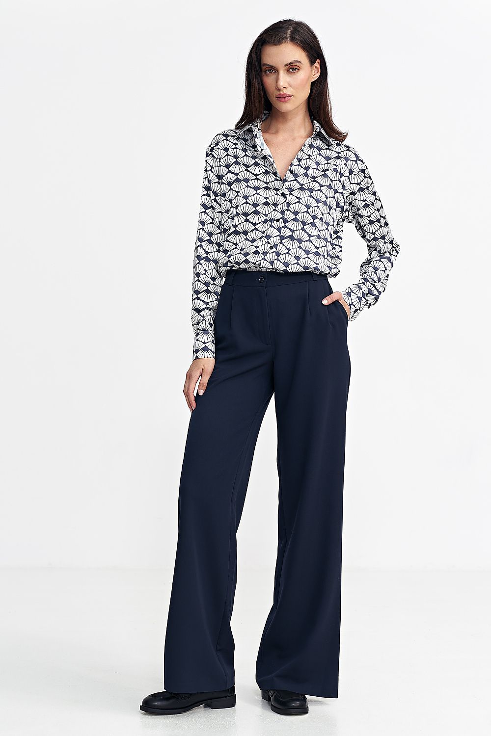 Women's relaxed fit pants with a mid-rise, decorative front pleats, and wide legs for a stylish yet comfortable look. Featuring a zip and button front, classic front pockets, imitation back pockets, and belt loops for versatility and functionality. Perfect for various occasions.






