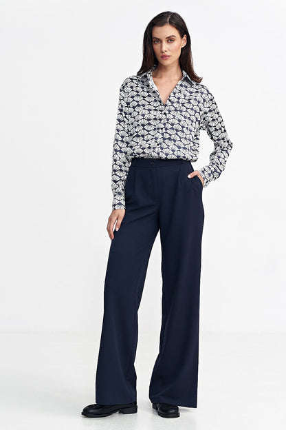 Women's relaxed fit pants with a mid-rise, decorative front pleats, and wide legs for a stylish yet comfortable look. Featuring a zip and button front, classic front pockets, imitation back pockets, and belt loops for versatility and functionality. Perfect for various occasions.






