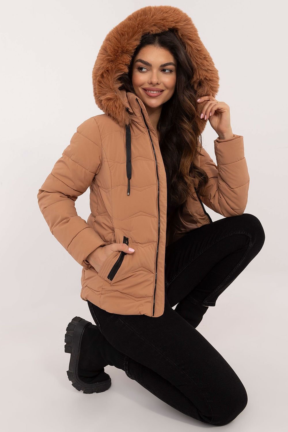 A stylish, high-quality quilted jacket made from polyester and filled with synthetic down for warmth and comfort. Featuring a short length, zipper closure, and detachable hood with drawstring closure, it provides protection from wind and rain. Side zippered pockets offer practicality, while the universal plain pattern ensures versatility for various styles.