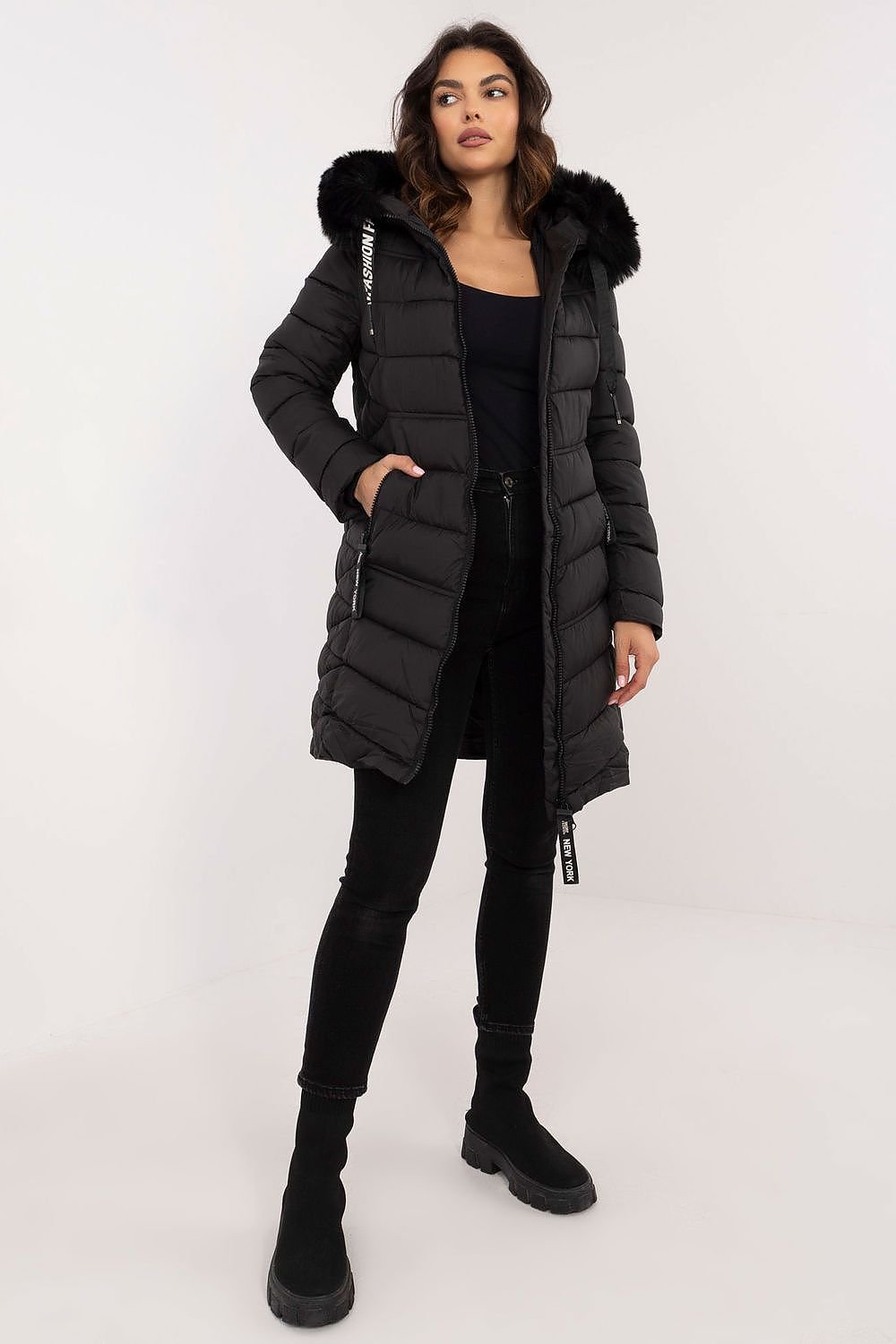 A stylish knee-length quilted jacket made of high-quality polyester with synthetic down filling for warmth. Featuring detachable fur for adaptable styling, an adjustable hood for wind and rain protection, side zippered pockets for secure storage, and a zipper closure for comfort. Its versatile design pairs easily with jeans or sports pants, making it a perfect choice for colder days.






