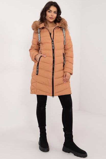 A stylish knee-length quilted jacket made of high-quality polyester with synthetic down filling for warmth. Featuring detachable fur for adaptable styling, an adjustable hood for wind and rain protection, side zippered pockets for secure storage, and a zipper closure for comfort. Its versatile design pairs easily with jeans or sports pants, making it a perfect choice for colder days.






