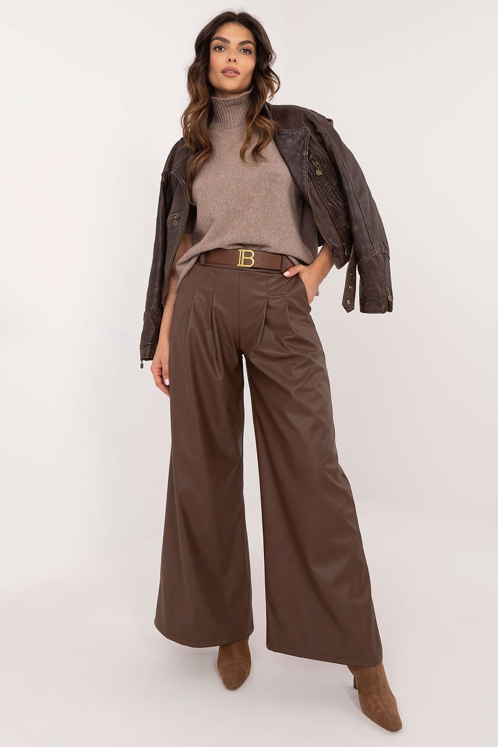 Women's eco-leather pants featuring a high rise with an elastic back waistband, slip-in side pockets, and a buckled waist for a perfect fit. Made from a blend of polyester and viscose, these stylish, wide-leg pants are ideal for both work and casual wear, offering comfort and modern elegance.






