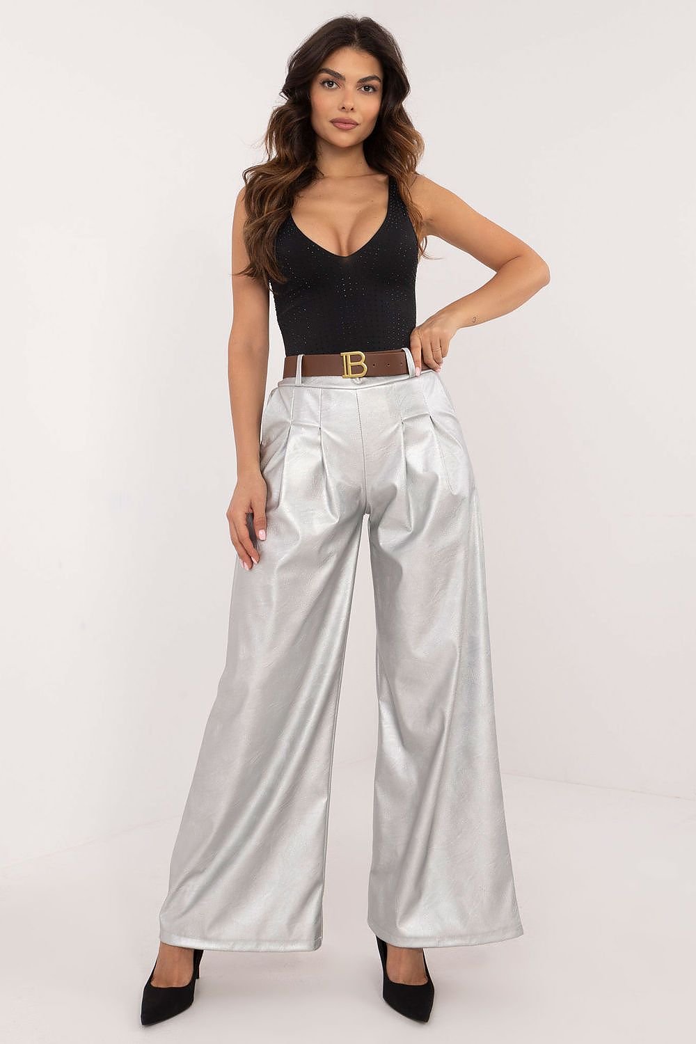 Women's eco-leather pants featuring a high rise with an elastic back waistband, slip-in side pockets, and a buckled waist for a perfect fit. Made from a blend of polyester and viscose, these stylish, wide-leg pants are ideal for both work and casual wear, offering comfort and modern elegance.






