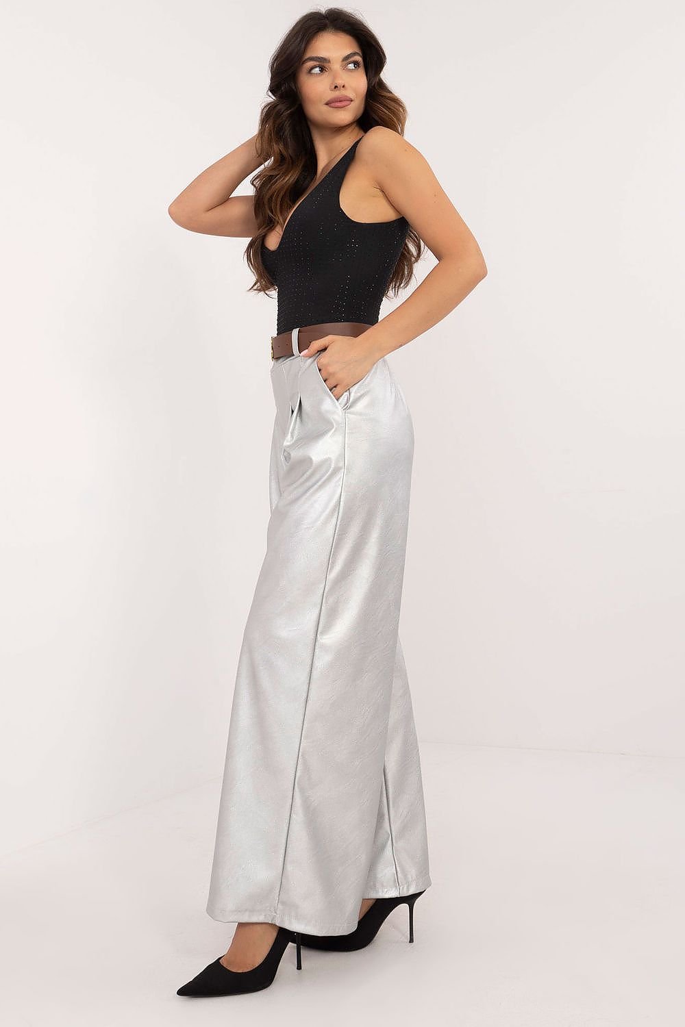 Women's eco-leather pants featuring a high rise with an elastic back waistband, slip-in side pockets, and a buckled waist for a perfect fit. Made from a blend of polyester and viscose, these stylish, wide-leg pants are ideal for both work and casual wear, offering comfort and modern elegance.






