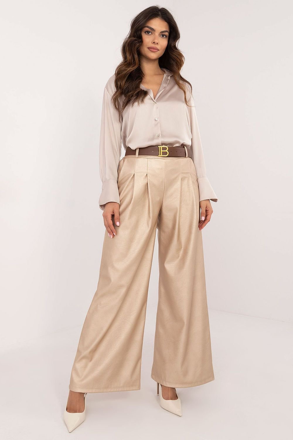 Women's eco-leather pants featuring a high rise with an elastic back waistband, slip-in side pockets, and a buckled waist for a perfect fit. Made from a blend of polyester and viscose, these stylish, wide-leg pants are ideal for both work and casual wear, offering comfort and modern elegance.






