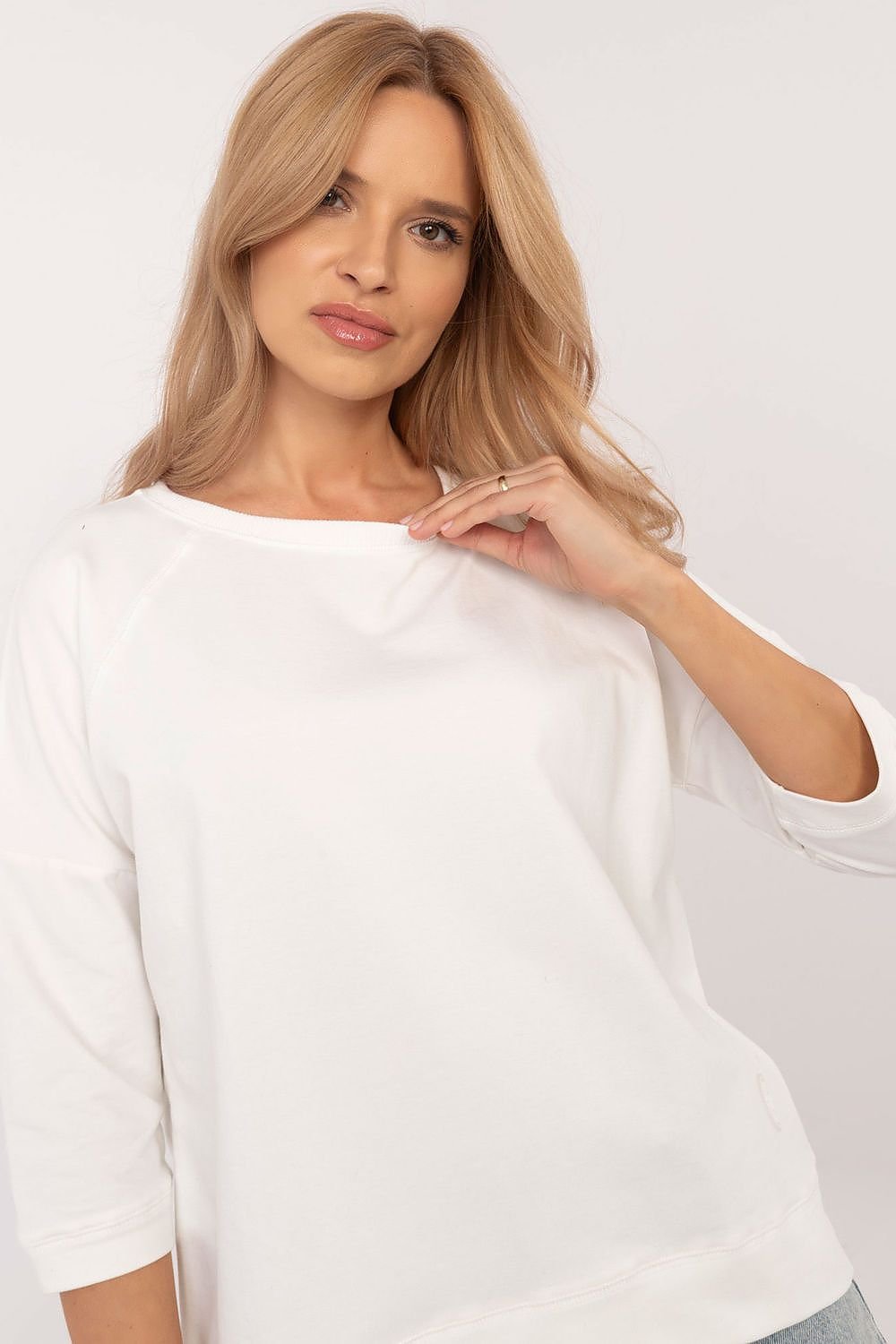 Soft and breathable cotton blouse with 3/4 sleeves, round neckline, and minimalist smooth pattern, perfect for everyday wear.