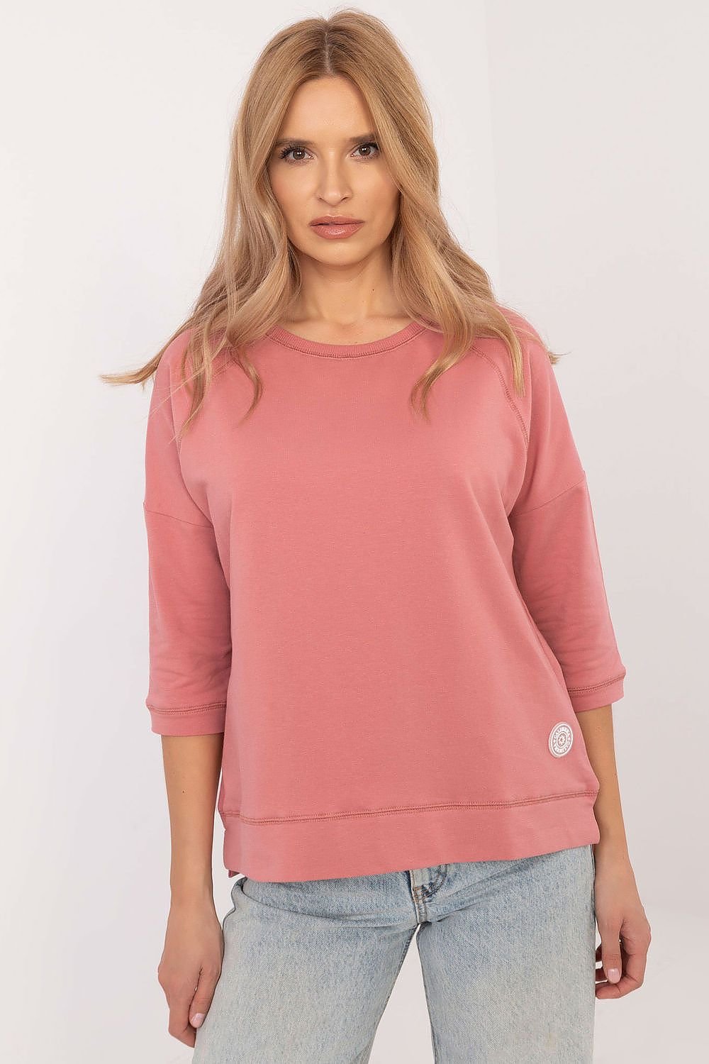 Soft and breathable cotton blouse with 3/4 sleeves, round neckline, and minimalist smooth pattern, perfect for everyday wear.