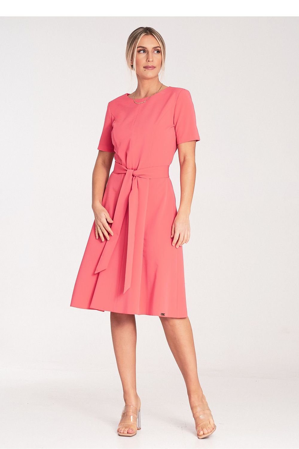  Timeless midi dress featuring pleats and short sleeves, tied at the waist with a fabric belt. The boat neckline and concealed back zipper offer a clean and elegant look, perfect for both casual and formal occasions.