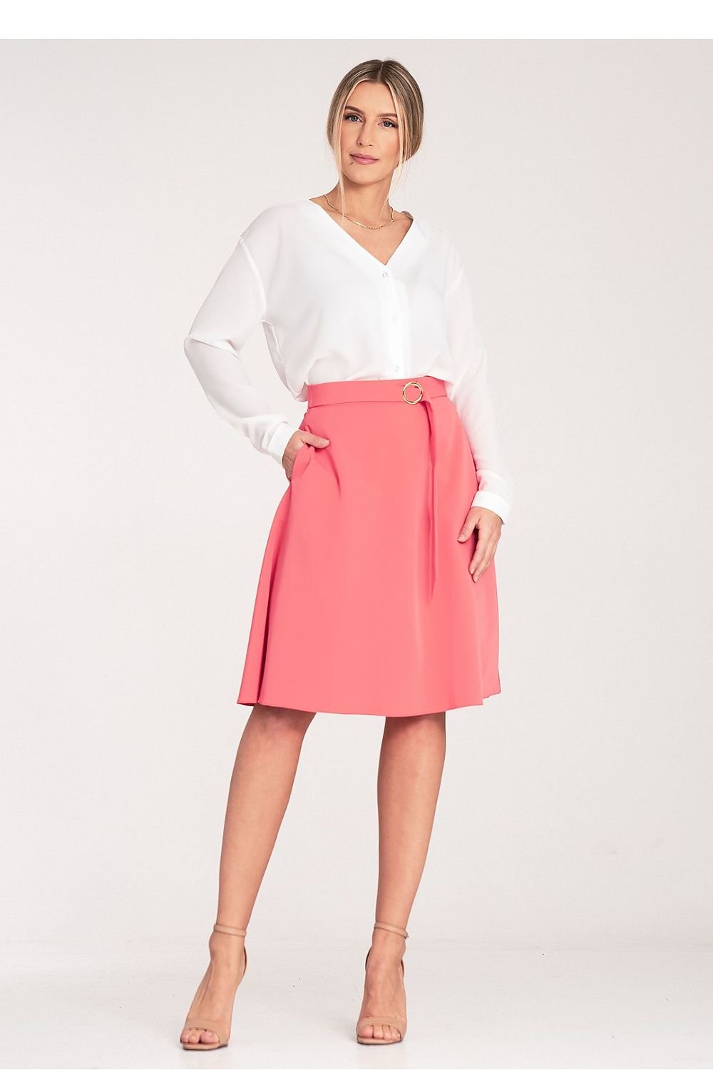 A flared, knee-length skirt with a loose fit, side seam pockets, a decorative buckle belt at the front, and a concealed back zip.

