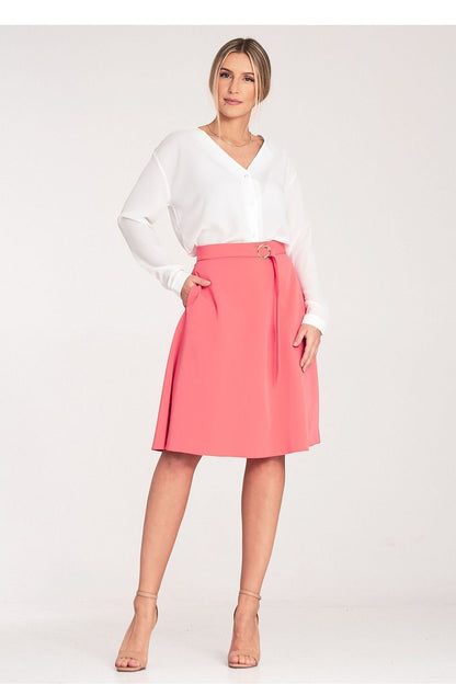 A flared, knee-length skirt with a loose fit, side seam pockets, a decorative buckle belt at the front, and a concealed back zip.

